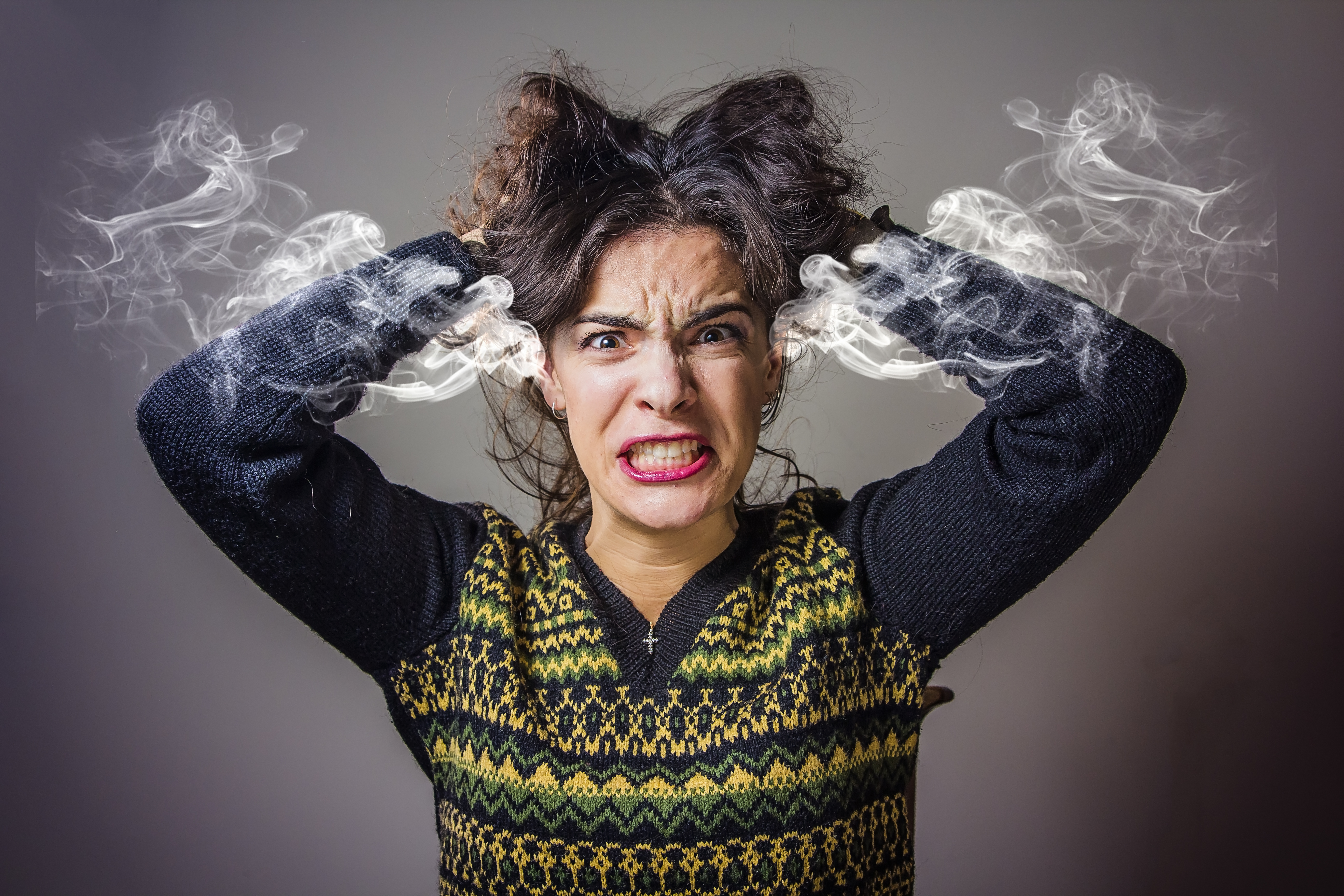 Smoke coming out of a woman's ears in frustration used for editorial purposes only